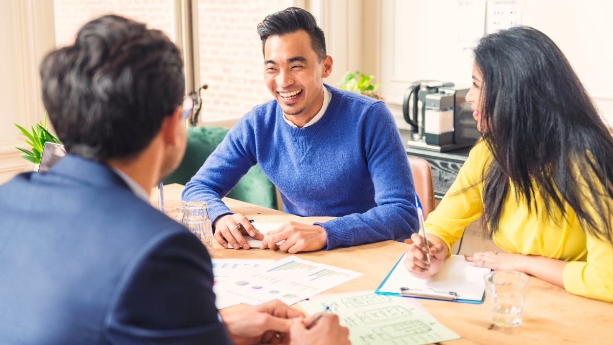 3 happy businesspeople having a meeting