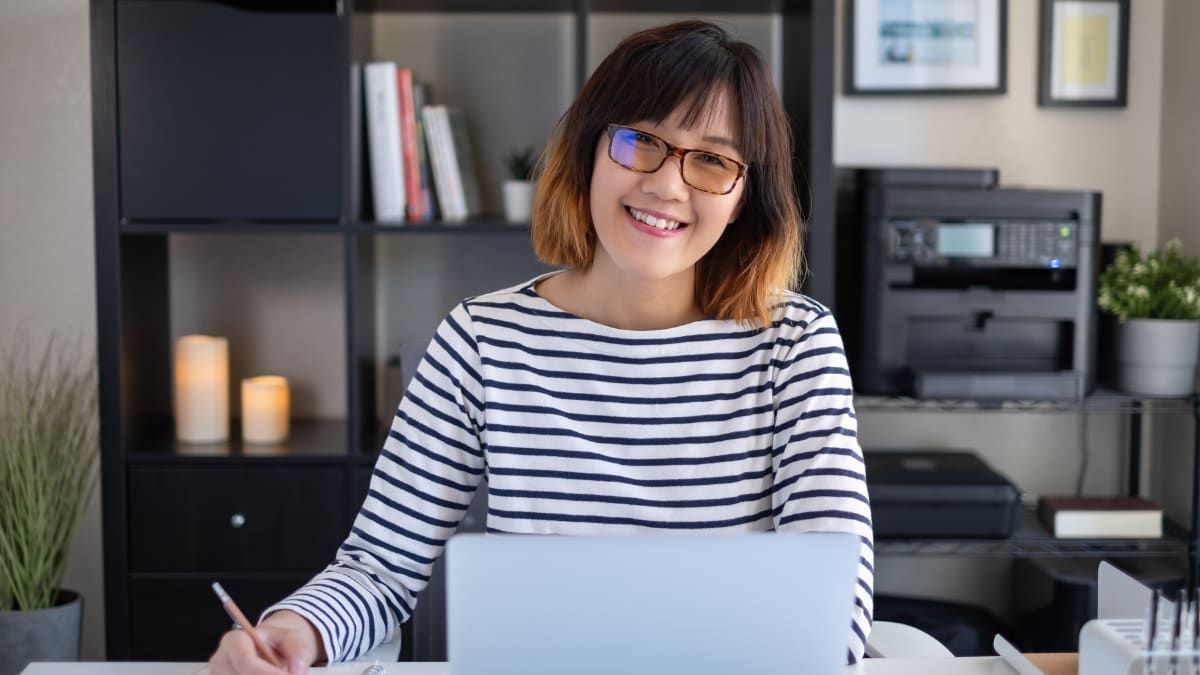 Happy young professional working at a desk