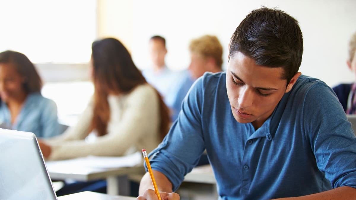 Students writing in a classroom