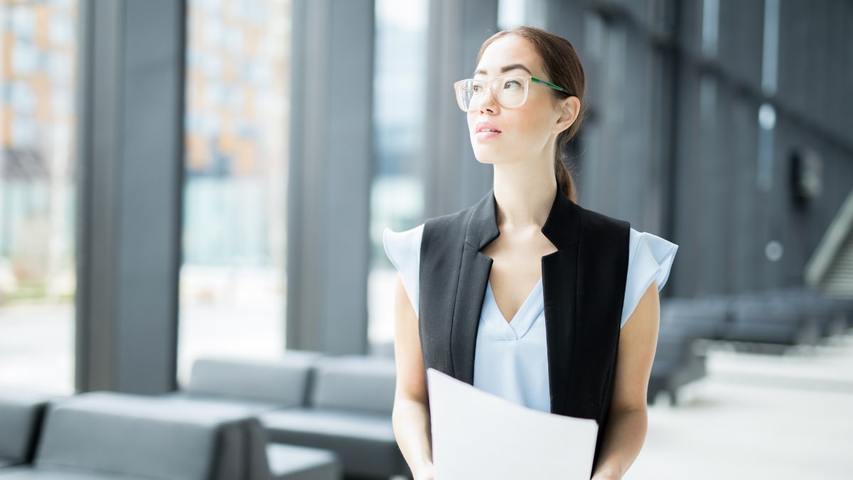 Woman with glasses thinking about economics