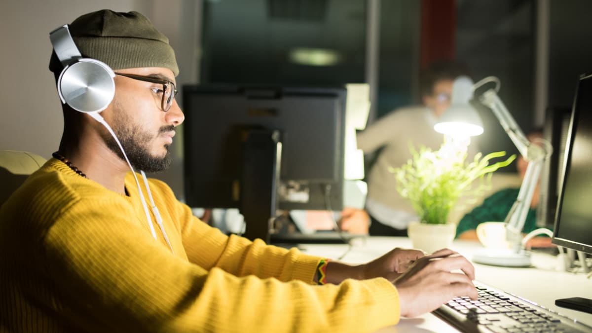 Man with a hat writing code