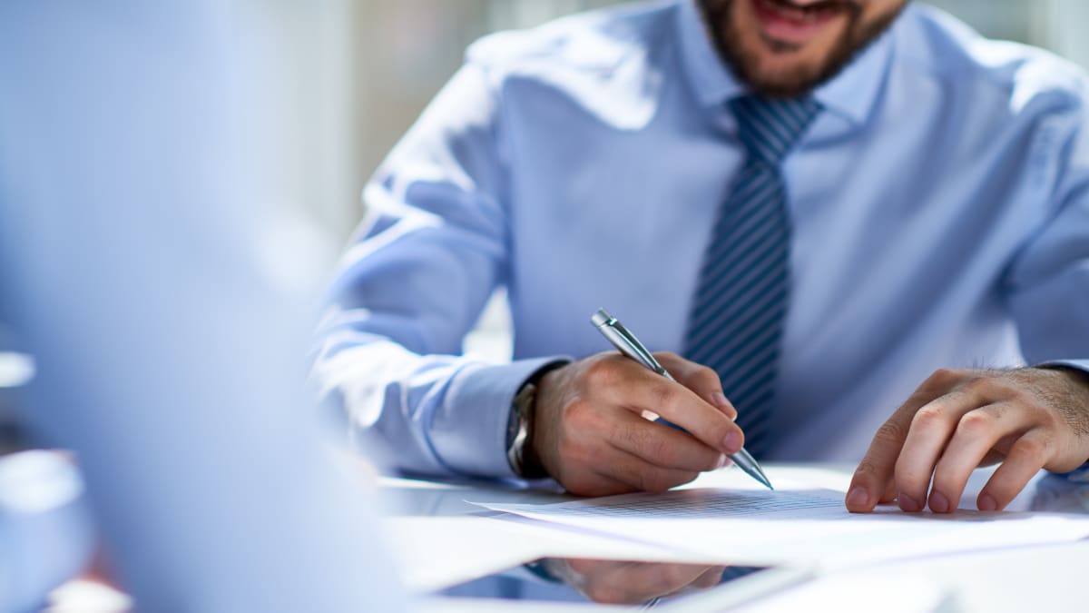 Businessman writing with a pen