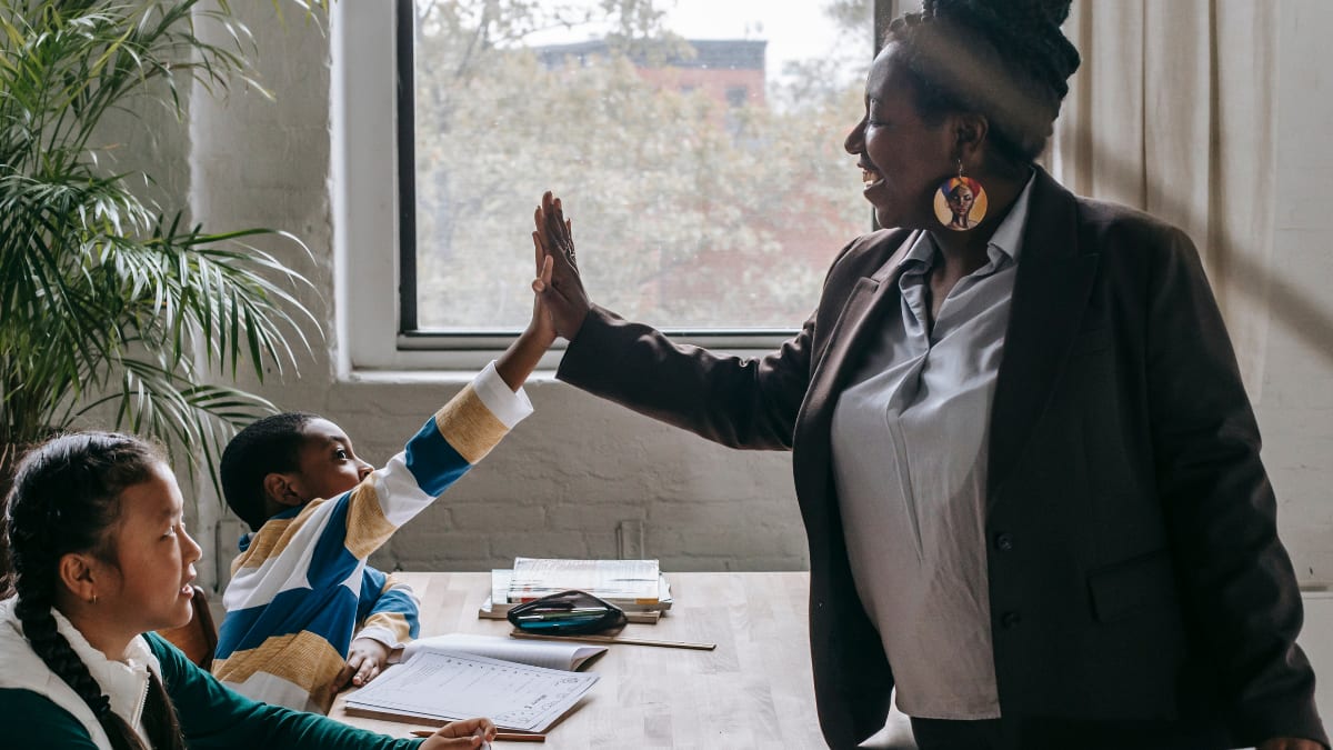 Teacher high fiving a student