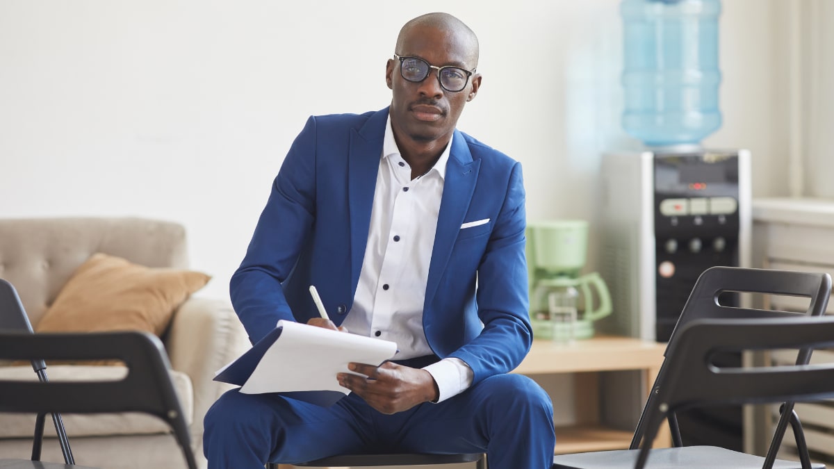 Male psychologist with glasses in a blue suit