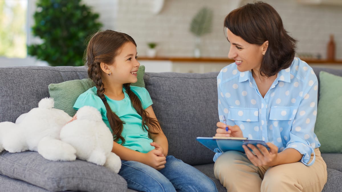 Female counselor talking to a young girl