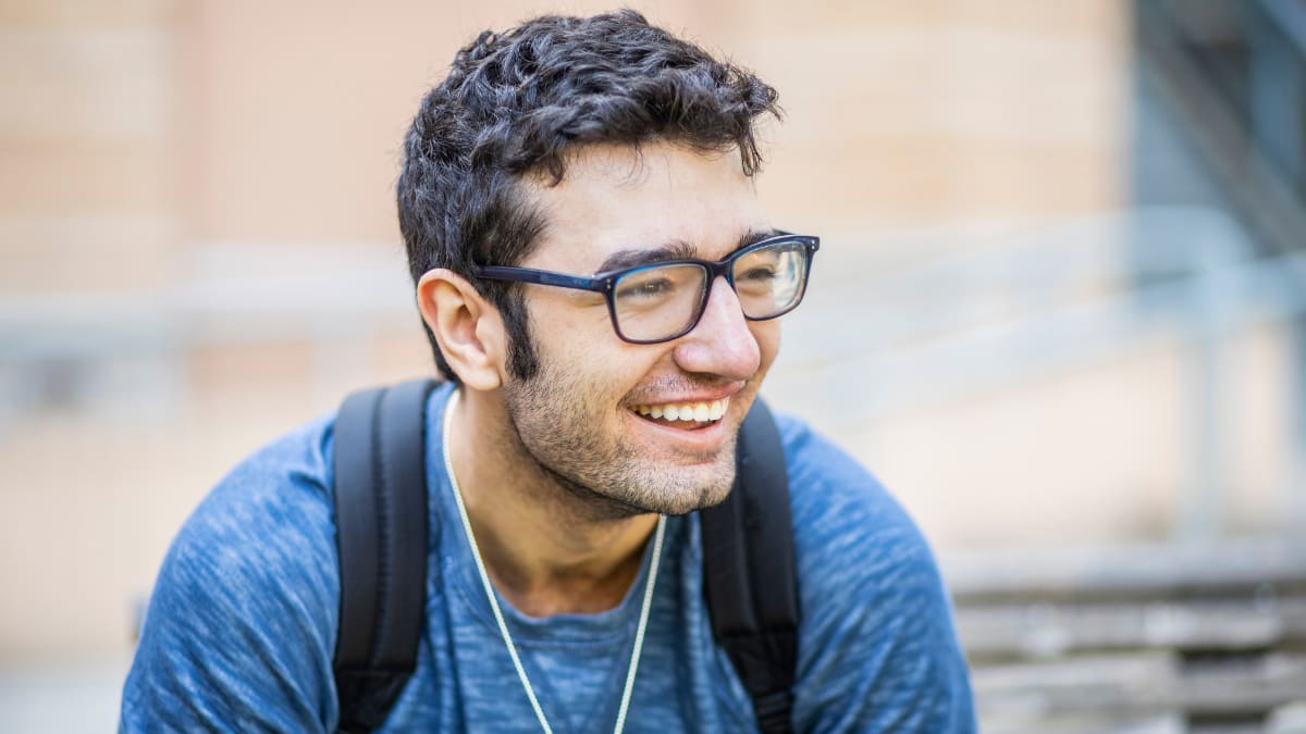 Male student smiling in a blue shirt