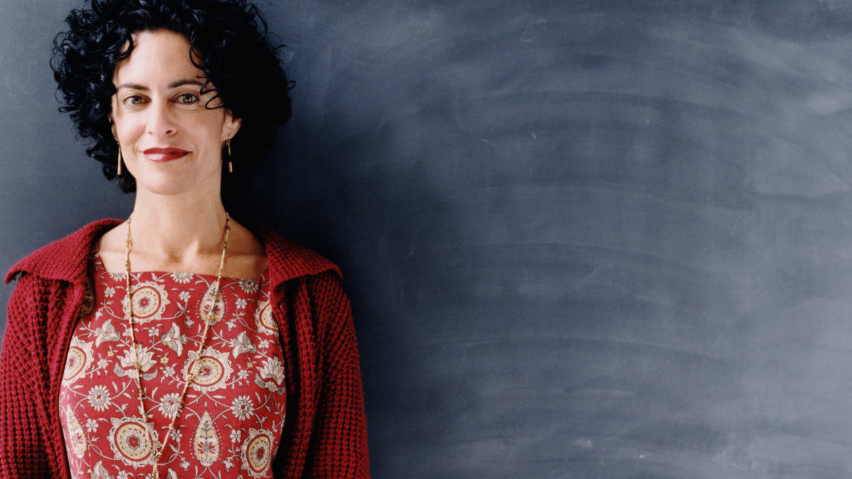 Woman standing in front of a blackboard