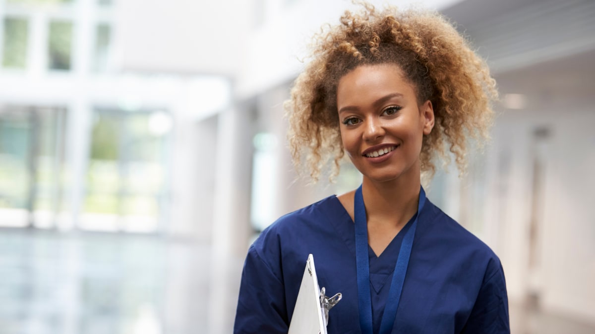 Smiling nurse with a clipboard