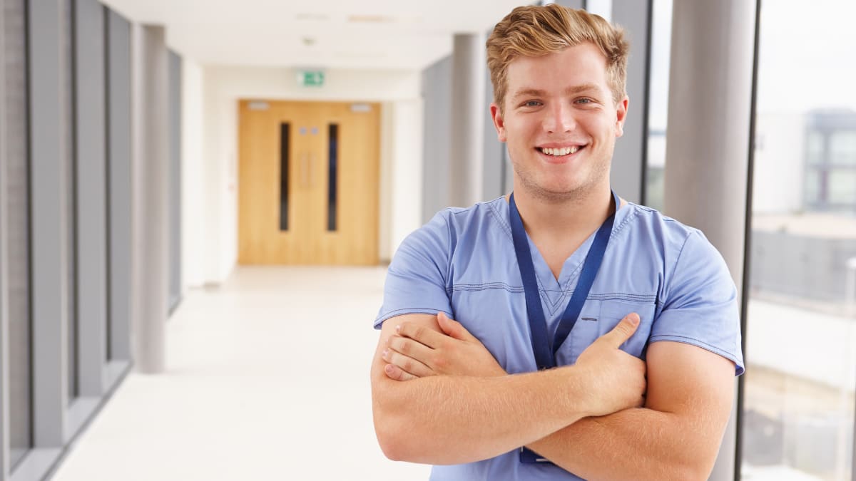 Smiling male nurse with folded arms