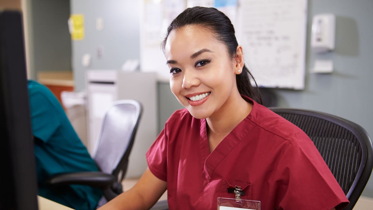 Smiling female nurse at a desk