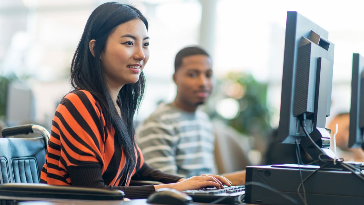 Happy student studying on a computer