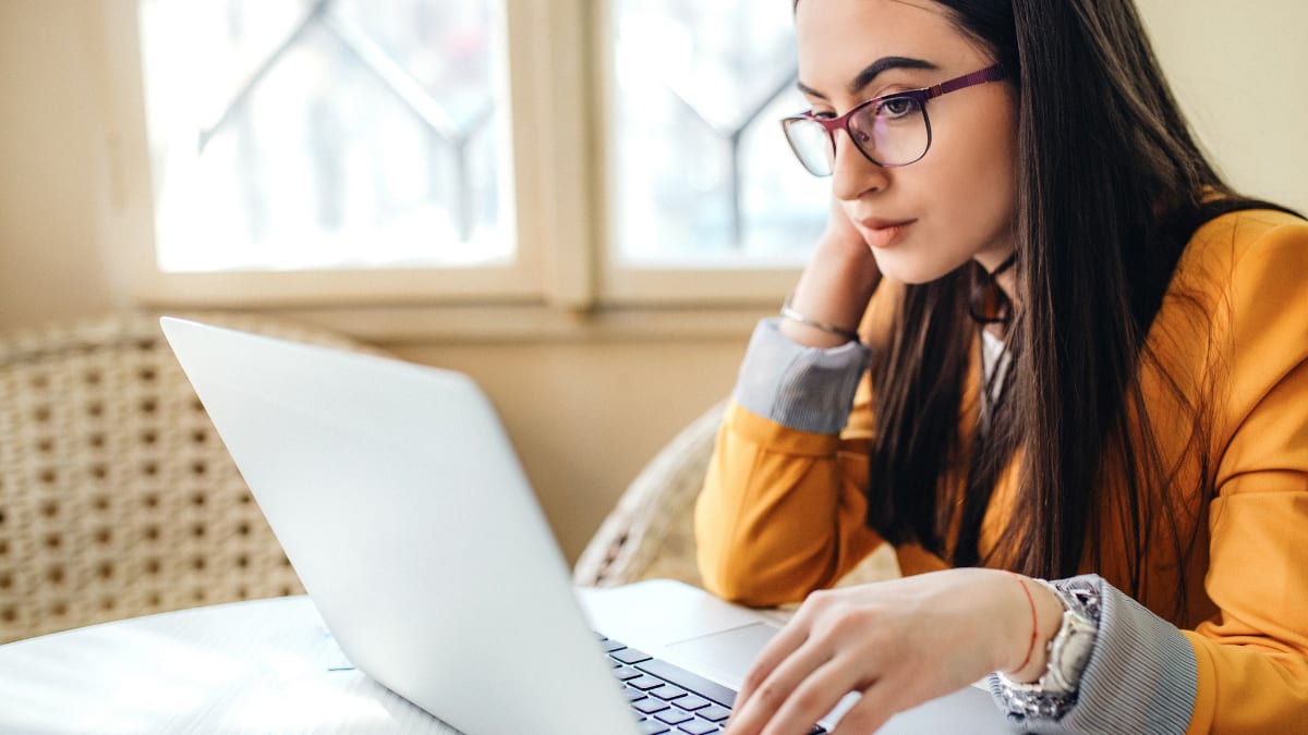 girl with glasses on a laptop