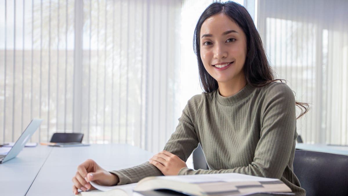 Happy female student studying