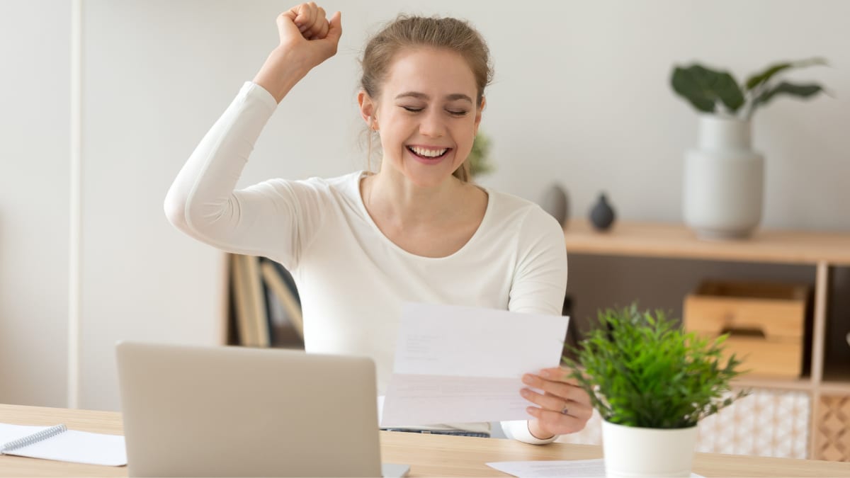 Young woman fist pumping after getting accepted to college