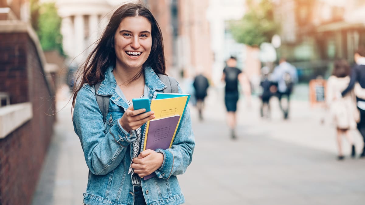 Female student laughing with her phone