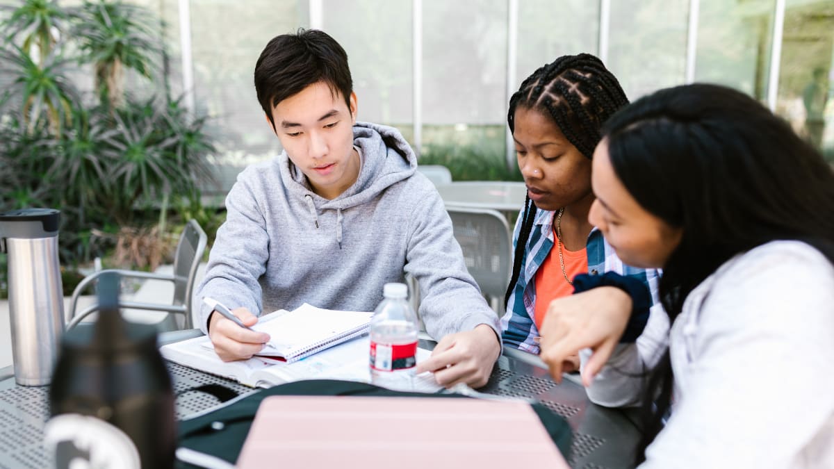 Three students working together outside