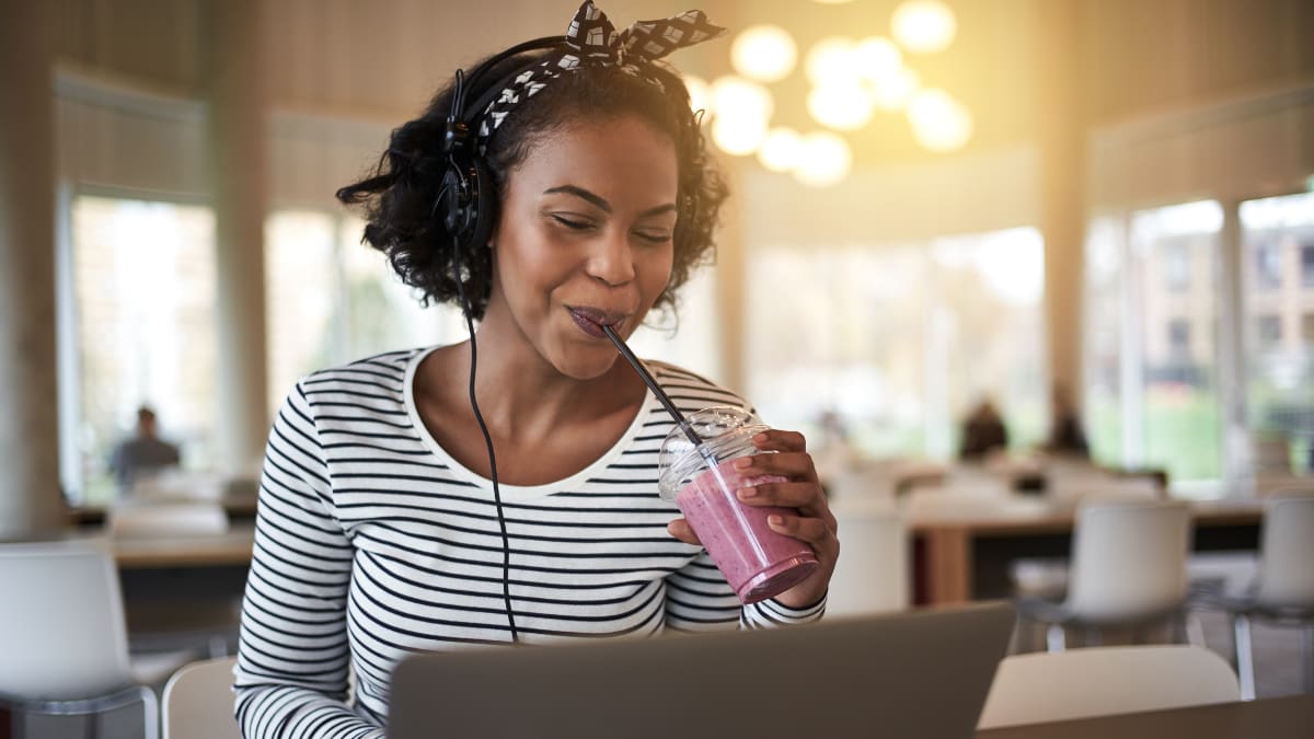 Happy student drinking a smoothie