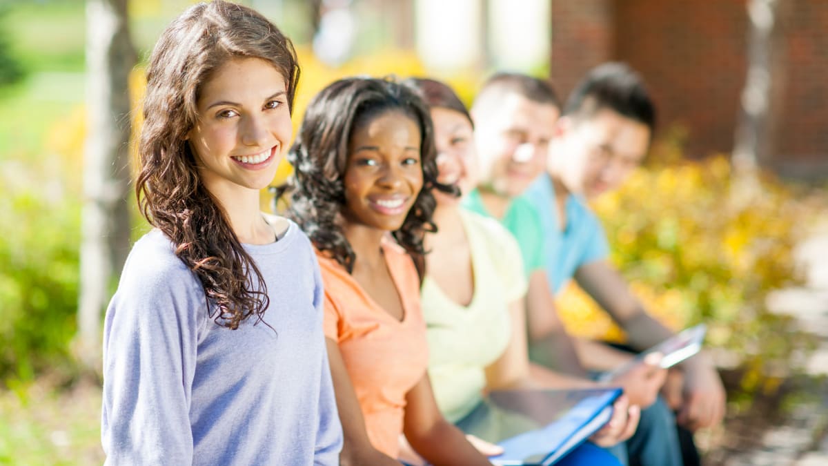 Happy students with notebooks