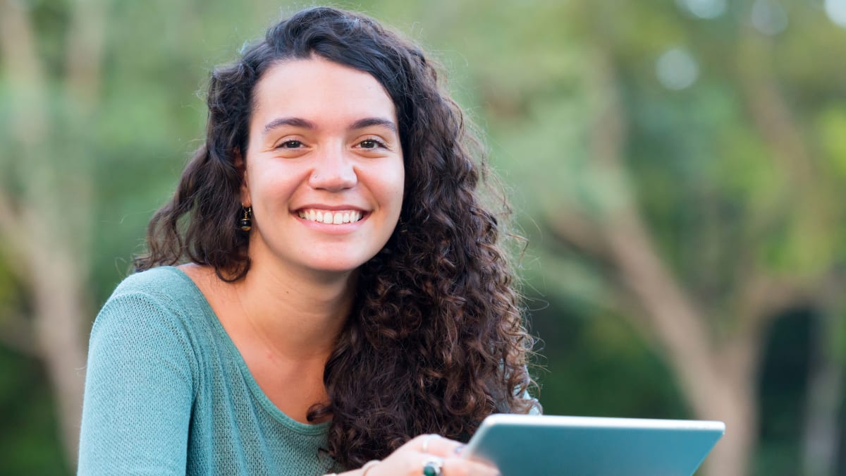 Smiling student on an electronic tablet