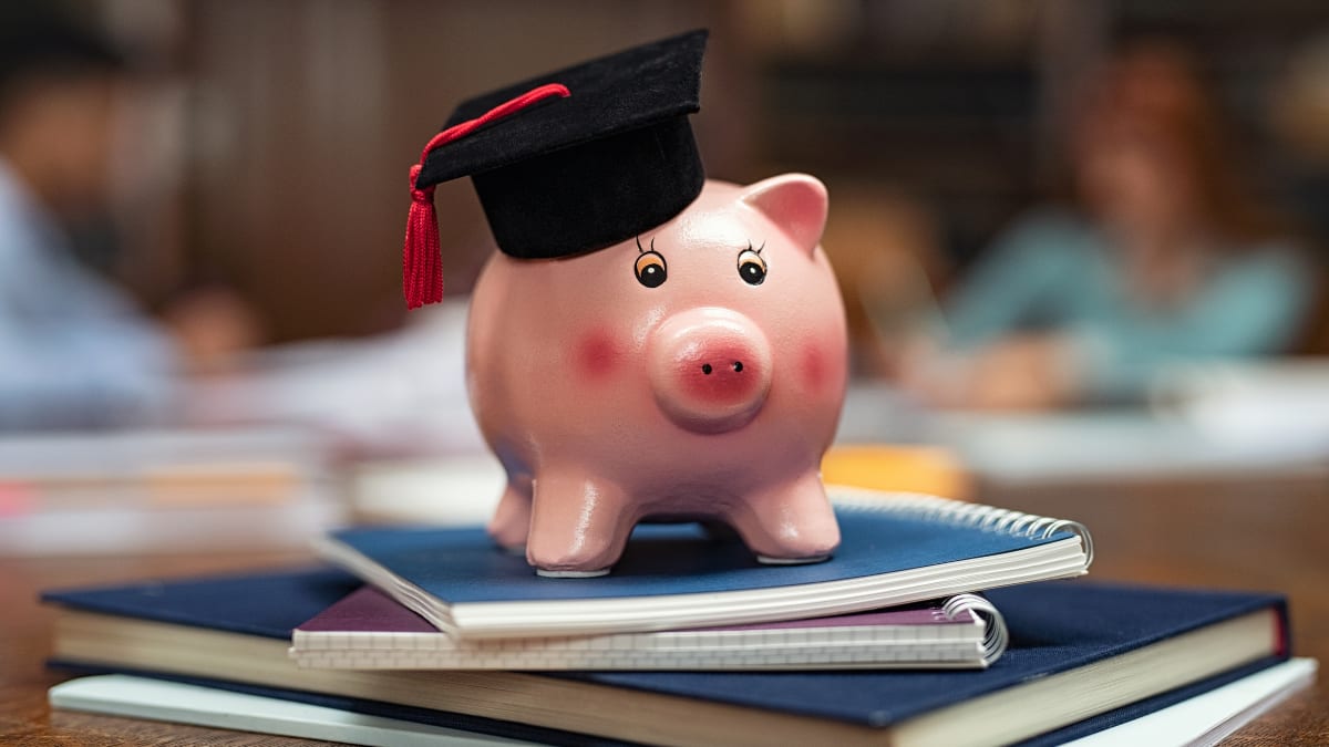 Piggy bank on a stack of notebooks