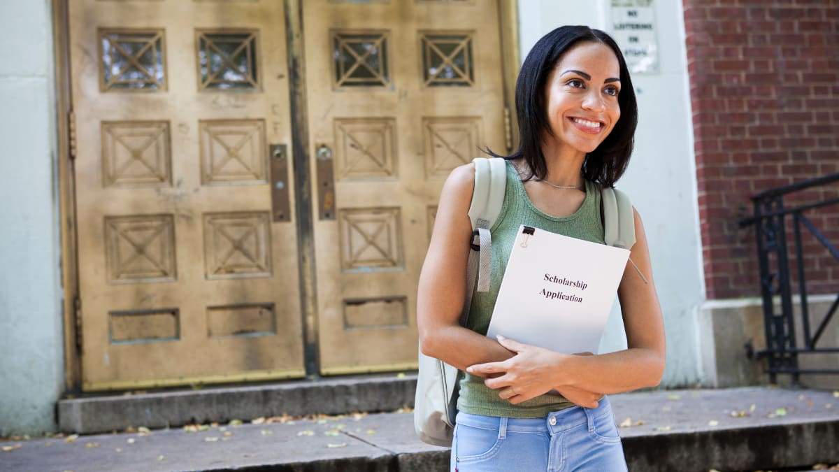 Female student standing outside a doorway