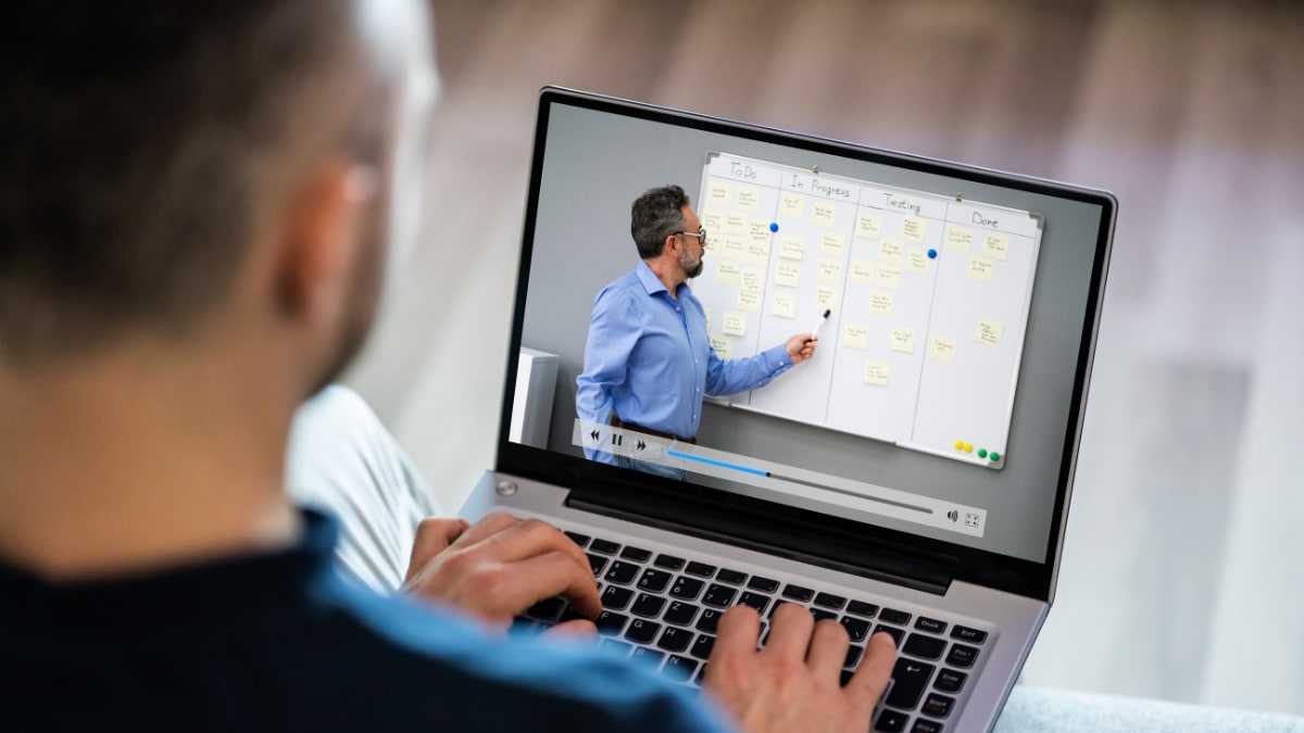 Student watching professor on laptop