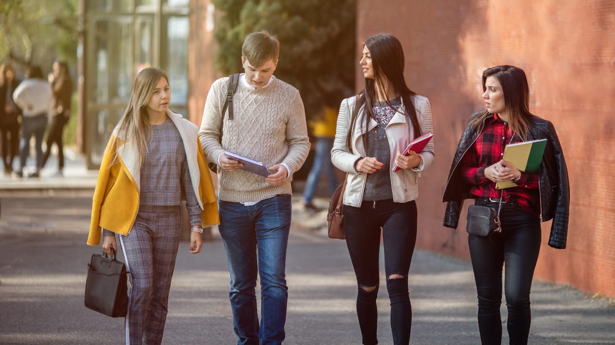 Four students walking outside