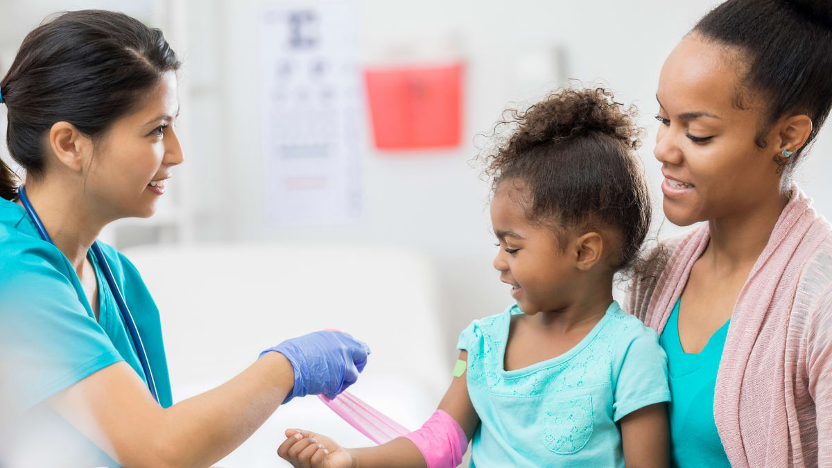 Phlebotomist helping a child in a hospital