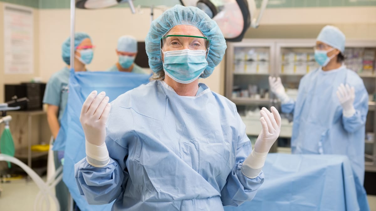 Surgical techs next to an operating table