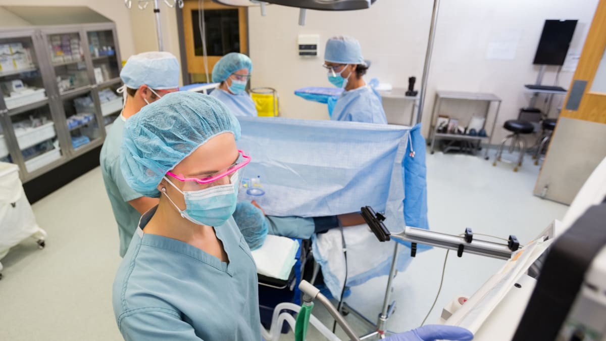 Surgical techs and surgeons in an operating room