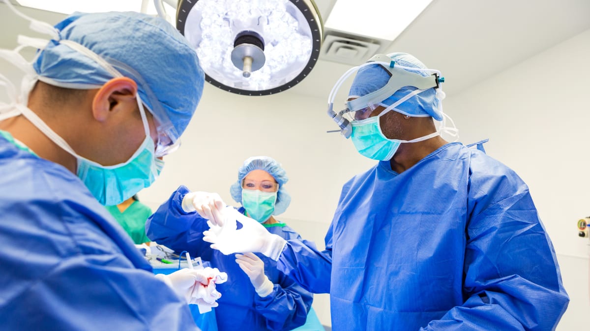 Surgeon and surgical techs operating