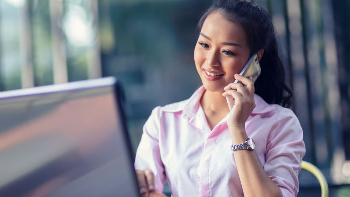 Woman in pink talking on the phone