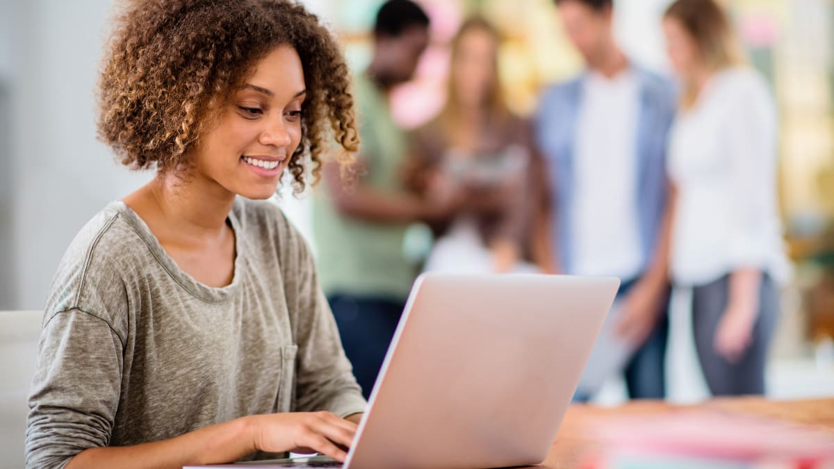 Woman smiling at her laptop