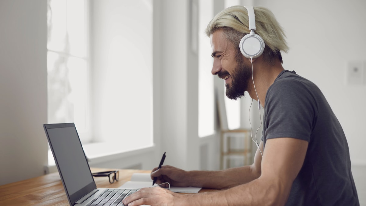 Man laughing while on his laptop