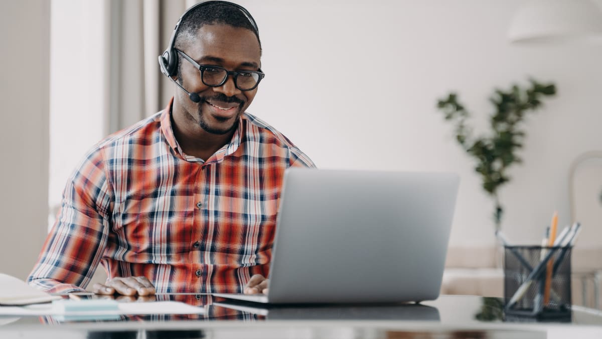 Man with glasses smiling on a video call