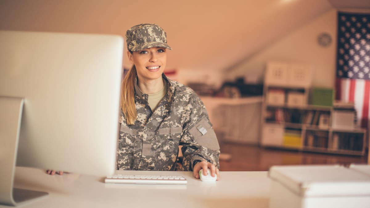 Military woman using a computer