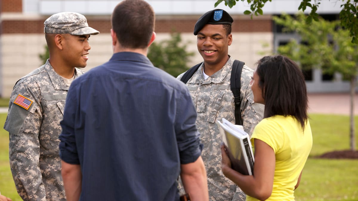 Two military students talking to civilian students