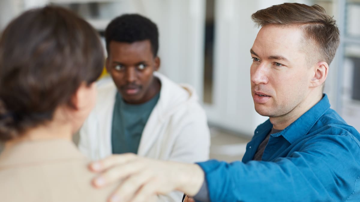 Psychologist with a hand on the shoulder of patient