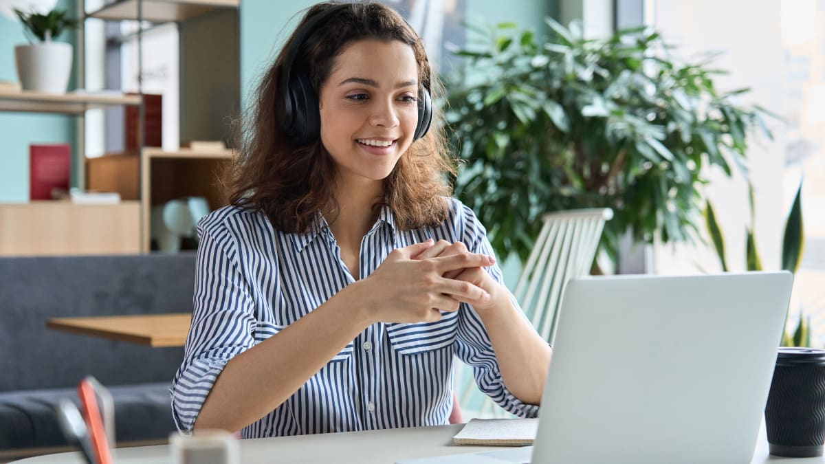 Female student smiling at laptop