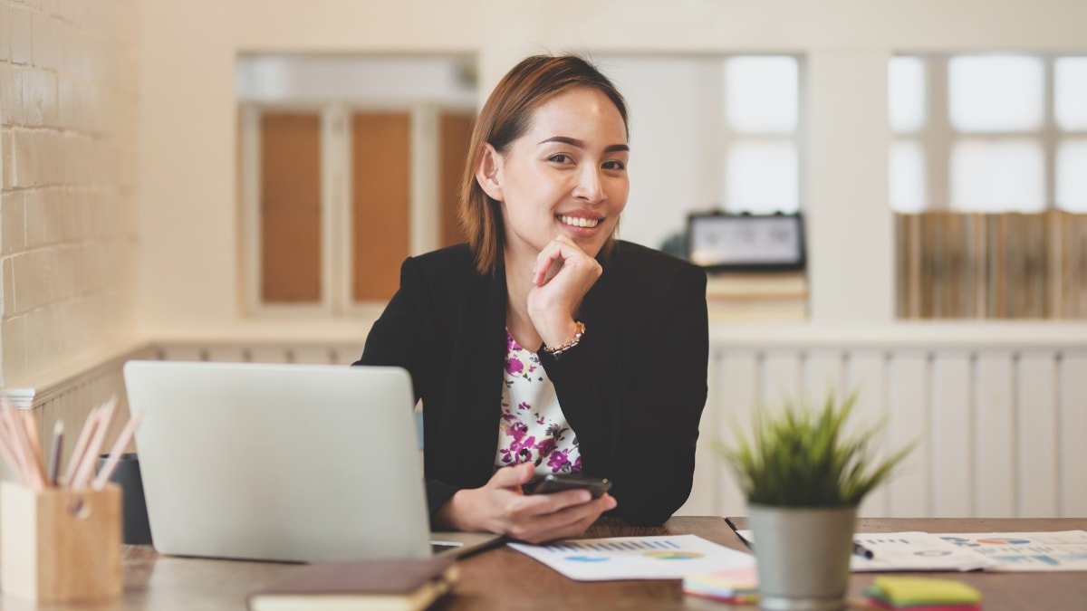 Business manager smiling at desk