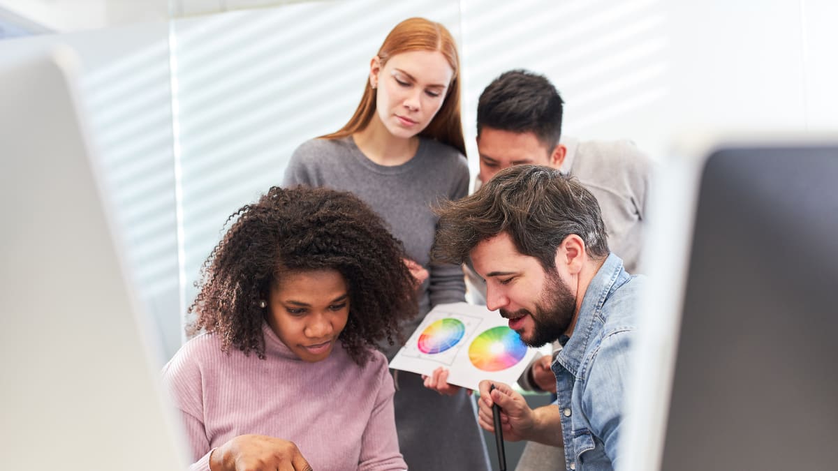 Four people working with a color palette