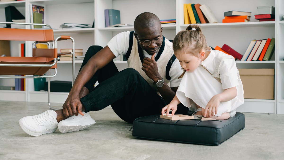 Man helping a child in psychology room