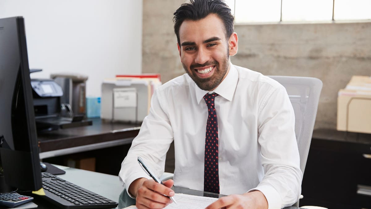 Man smiling in suit and tie