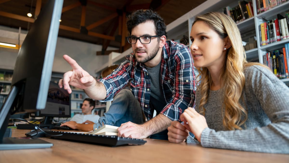 Two people working together on a computer