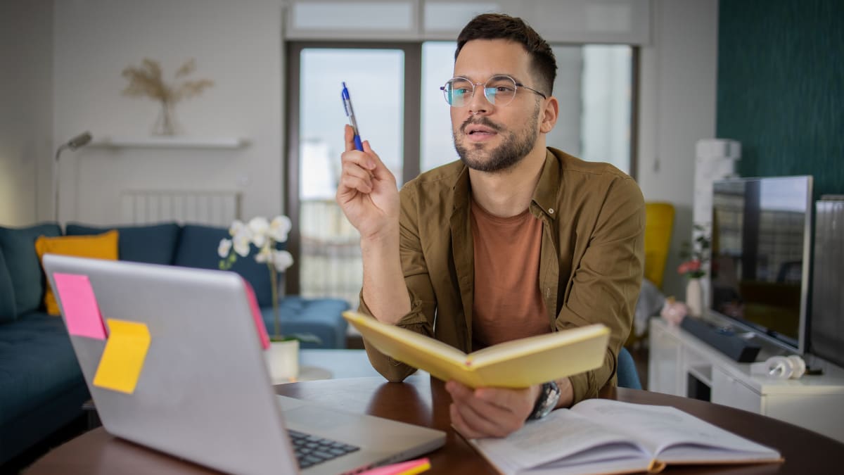 Man with glasses working from home