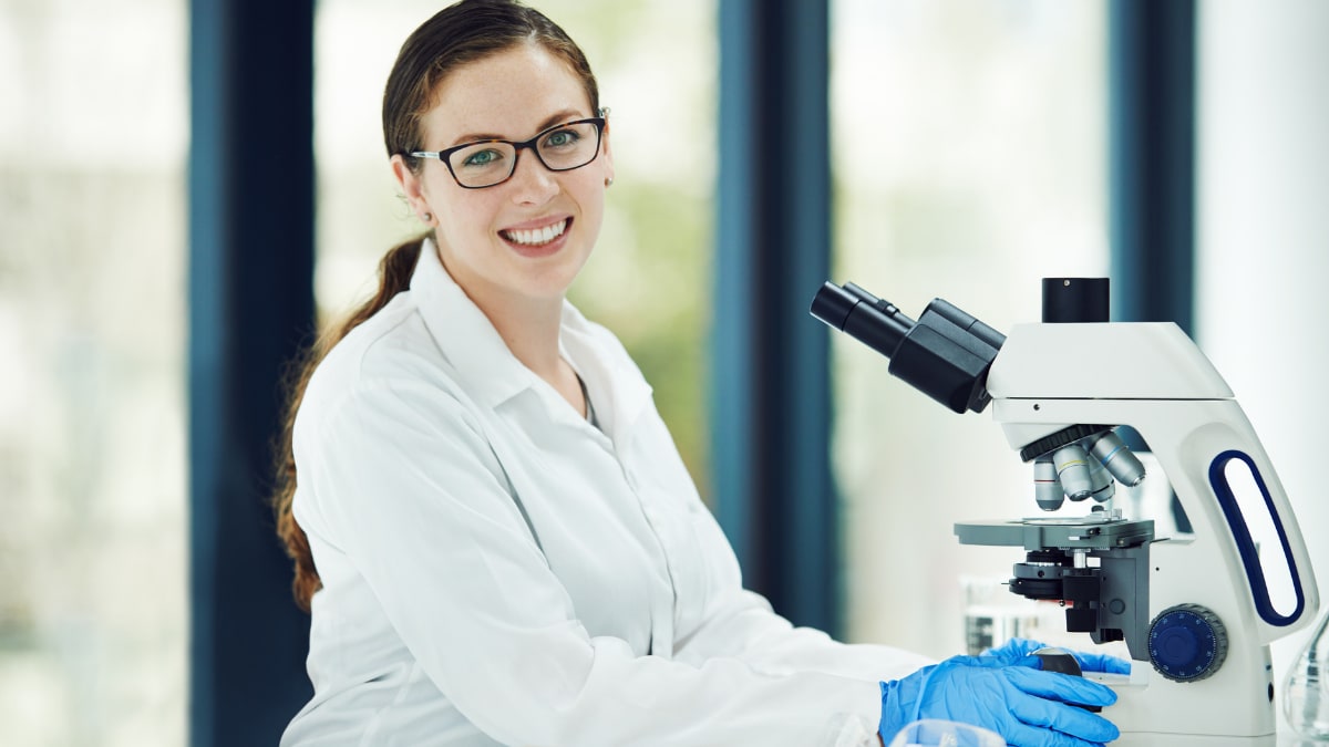 Woman smiling in a lab