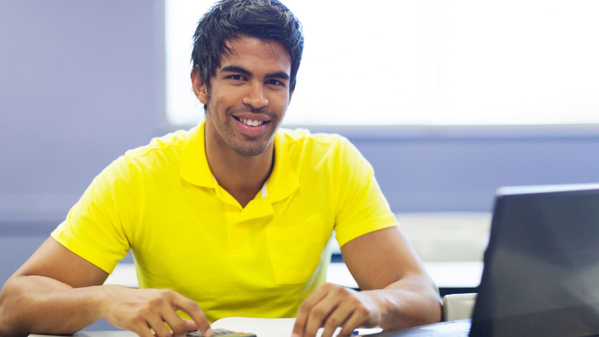 Man smiling in a bright yellow shirt