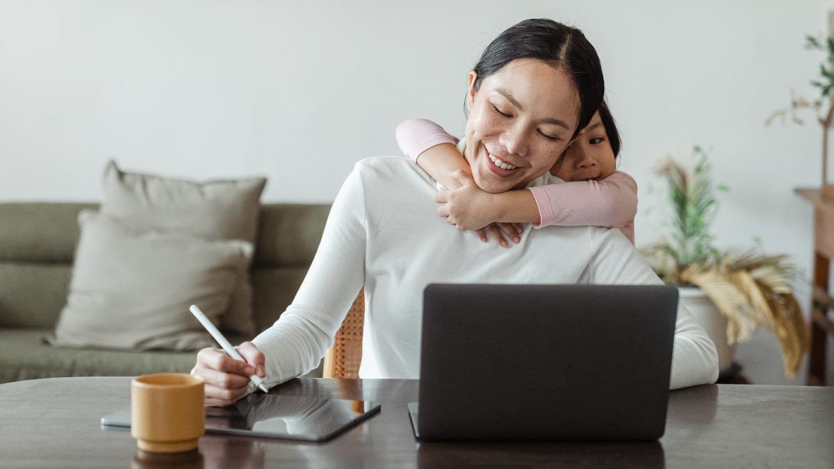 Woman working from home with daughter