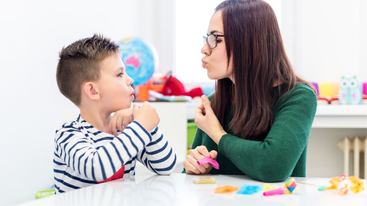 speech therapist and child learning correct pronunciation