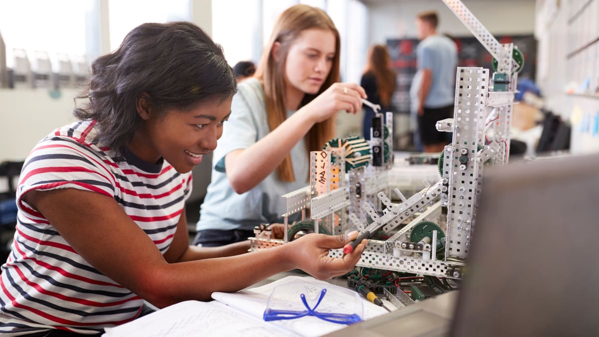 Two students working in robotics or engineering